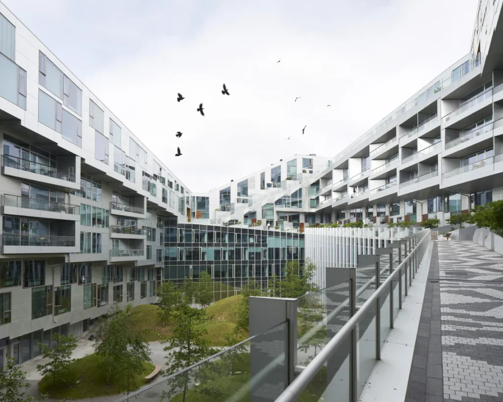 Birds flying through the inner courtyard of the 8 House by BIG in Copenhagen