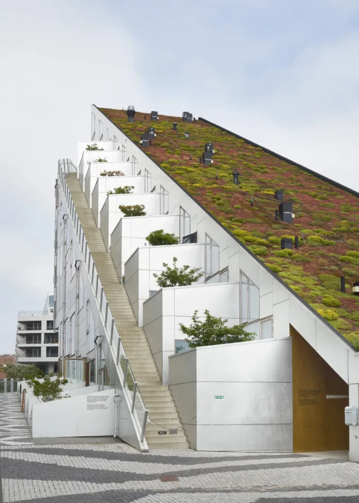 Sloping roof and planted terraces of the 8 House by BIG in Copenhagen