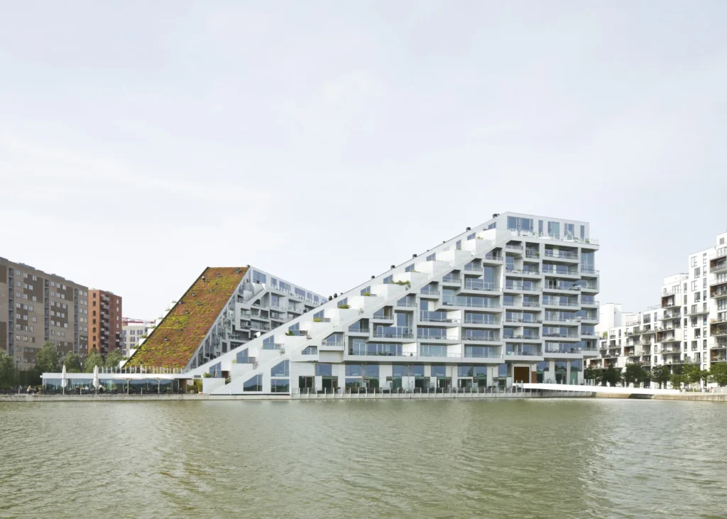 8 House residential complex reflected in the canal in Ørestad, Copenhage