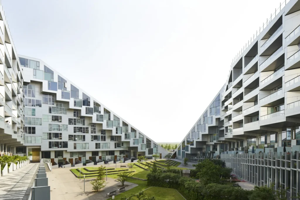Angled facades and balconies looking into the green trees and planting the inner courtyard of the 8 House by BIG