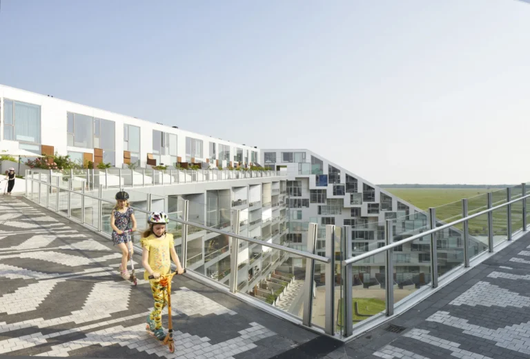 Kids riding scooters on the promenade path of the 8 House in Ørestad, Copenhagen by BIG / Bjarke Ingels Grpoup