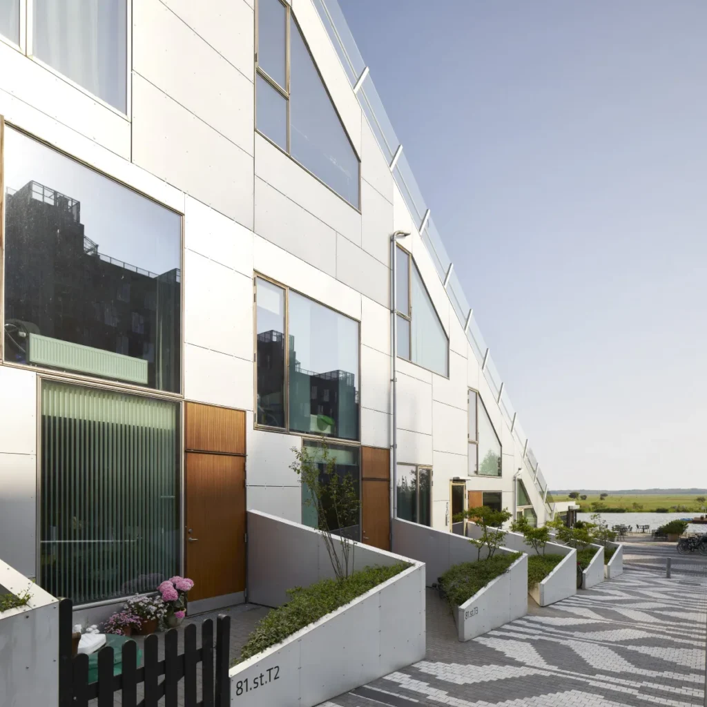 Ground-level townhouse entrances at the 8 House by BIG in Copenhagen