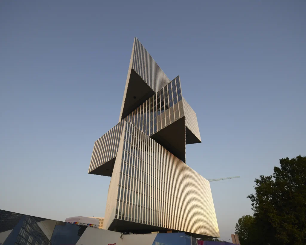 Golden evening light on volumes of nHow hotel Amsterdam RAI by Rem Koolhaas / OMA