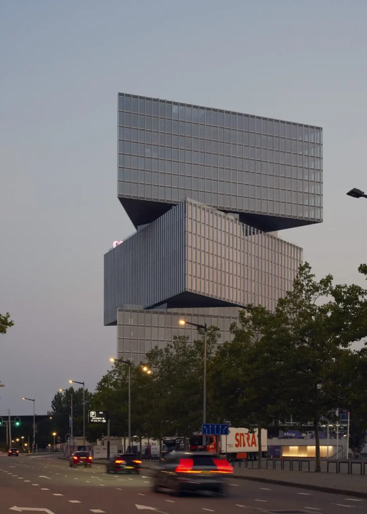 Three cantilevered volumes of nHow Amsterdam RAI Hotel by OMA seen from street level