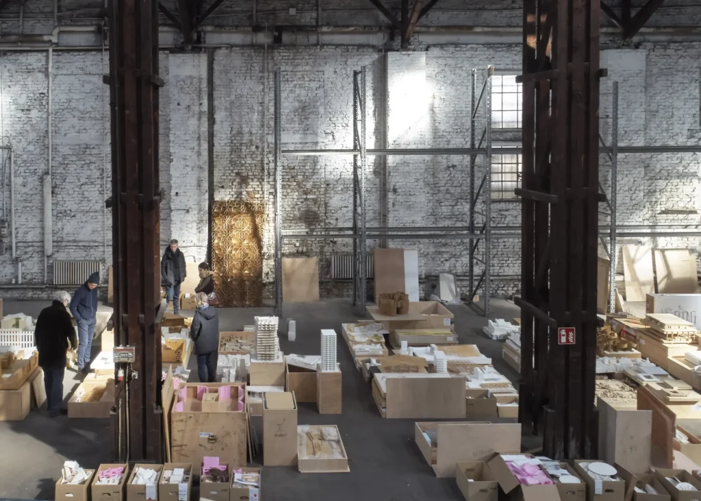 Architects examining models in warehouse during preparation of Revolutions of Choice exhibition