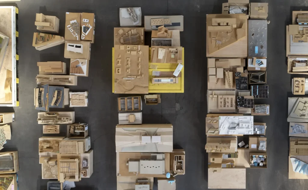 Overhead arrangement of mixed-material building models for Barkow Leibinger archive