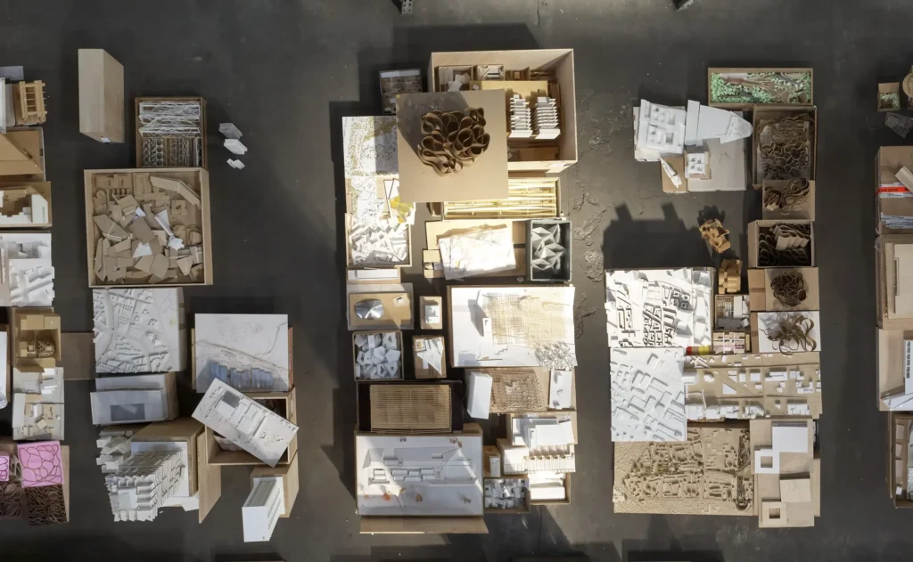 Aerial photograph of hundreds of cardboard and plaster models laid out for Barkow Leibinger exhibition