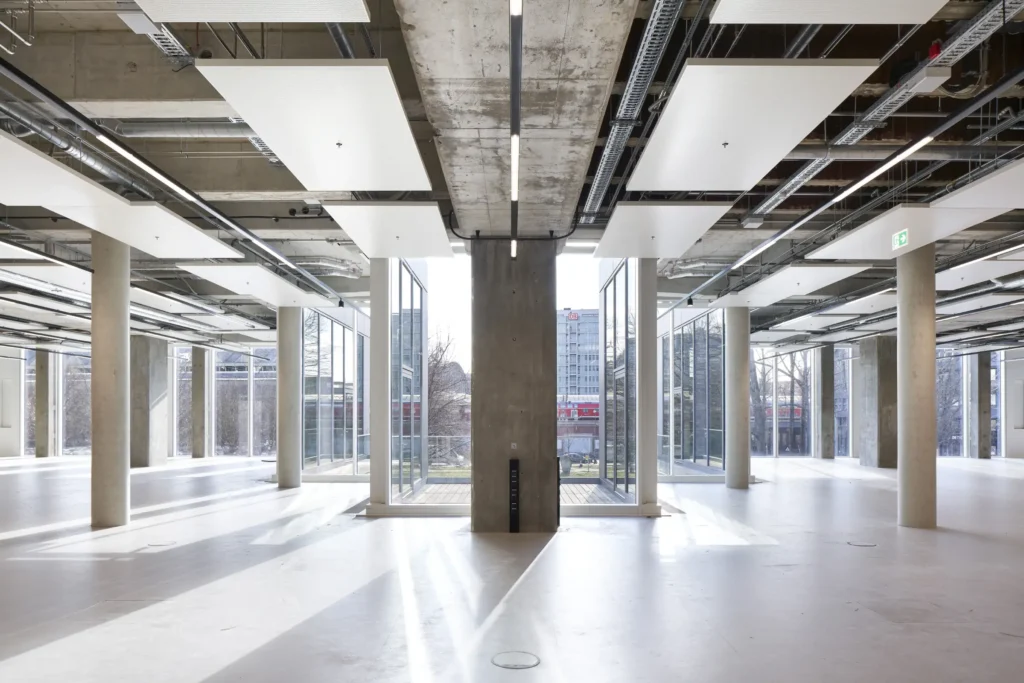 Raw office floor with exposed concrete structure and steel beams at UP! Berlin