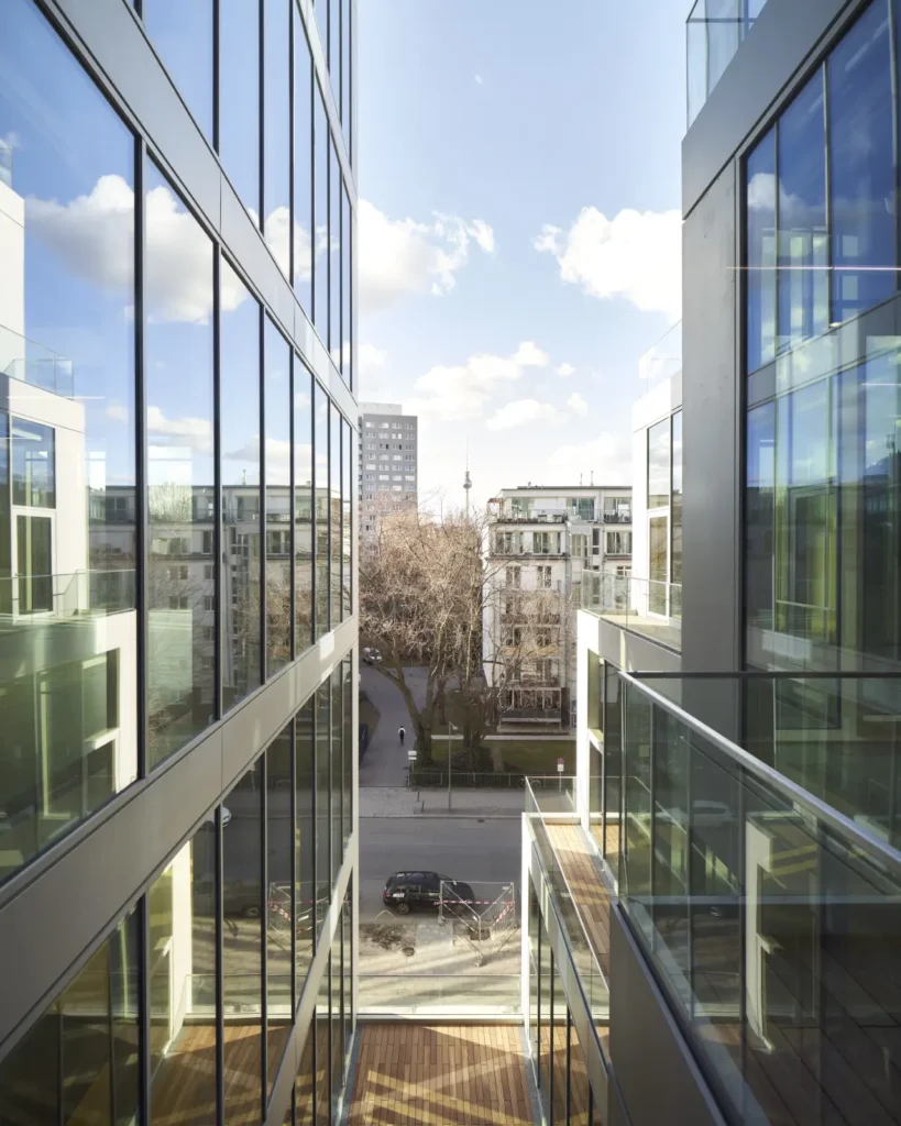 View to Alexanderplatz through funnel-shaped glass facade cut at UP! Berlin by Jasper Architects