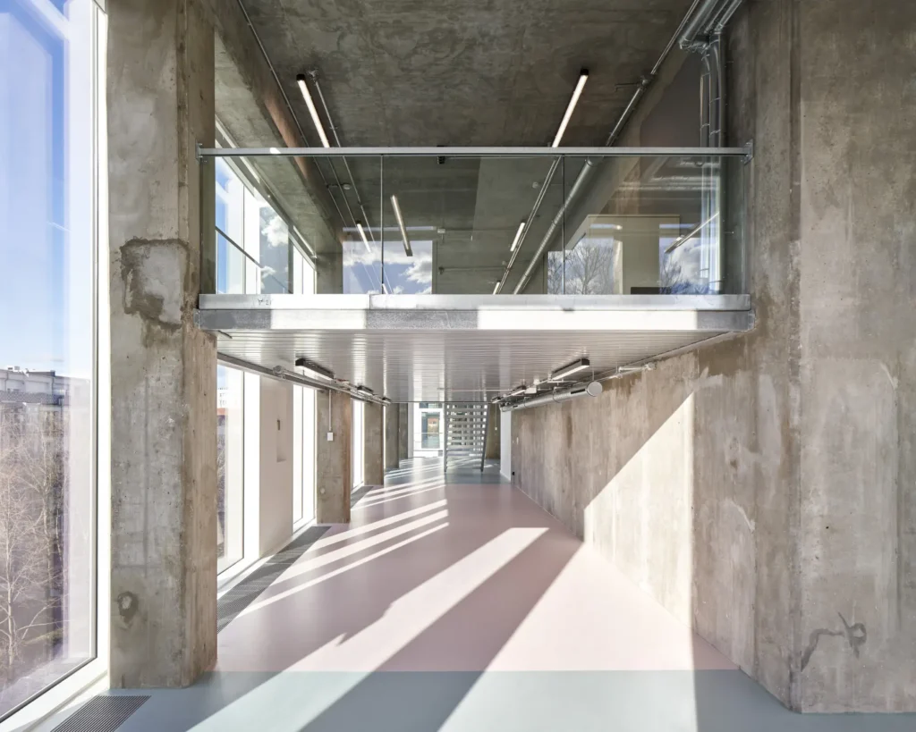 Double-height glass facade at funnel opening flooding interior with natural light at UP! Berlin