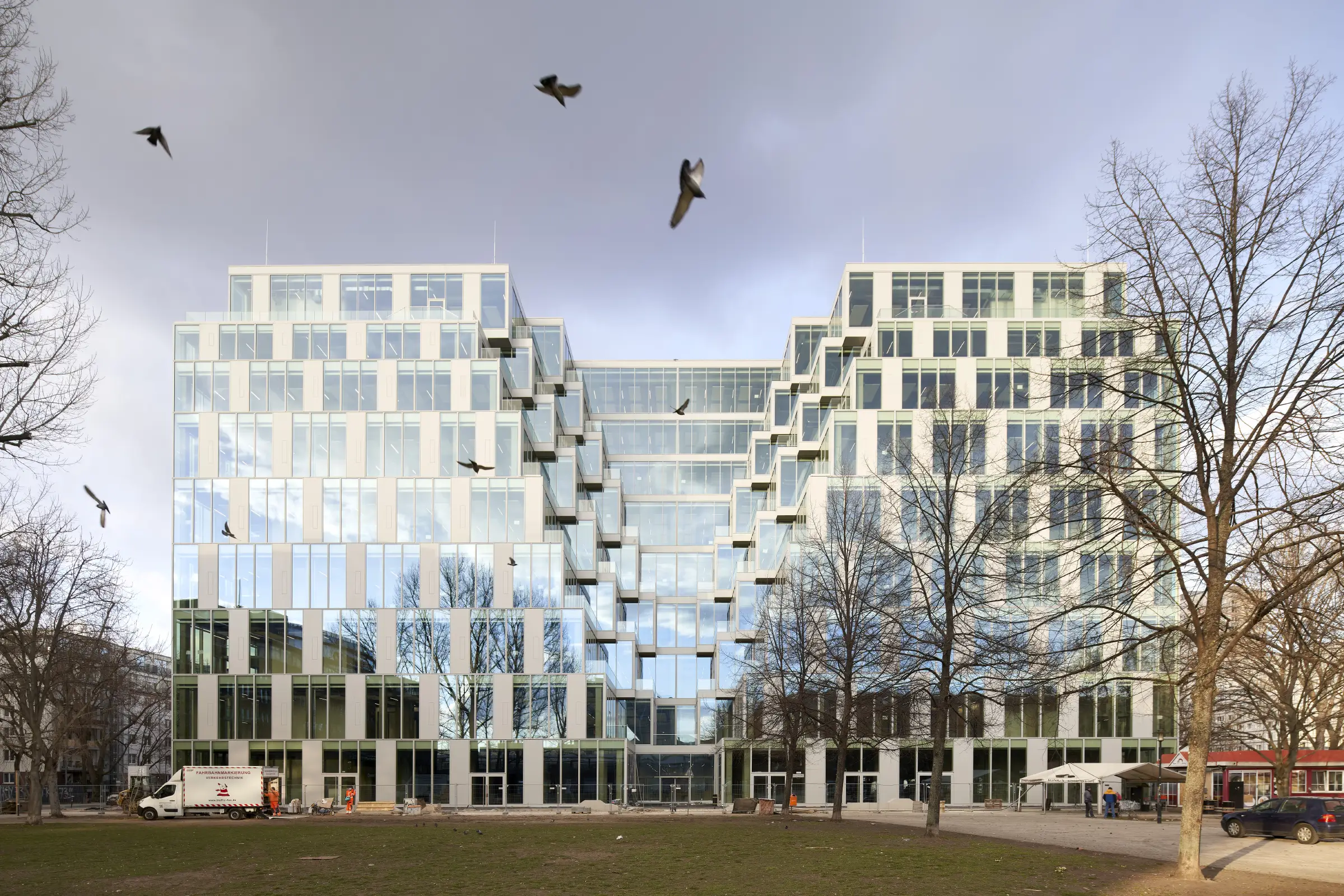Birda in the dramatic sky at transformed Centrum Warenhaus in Berlin by Jasper Architects