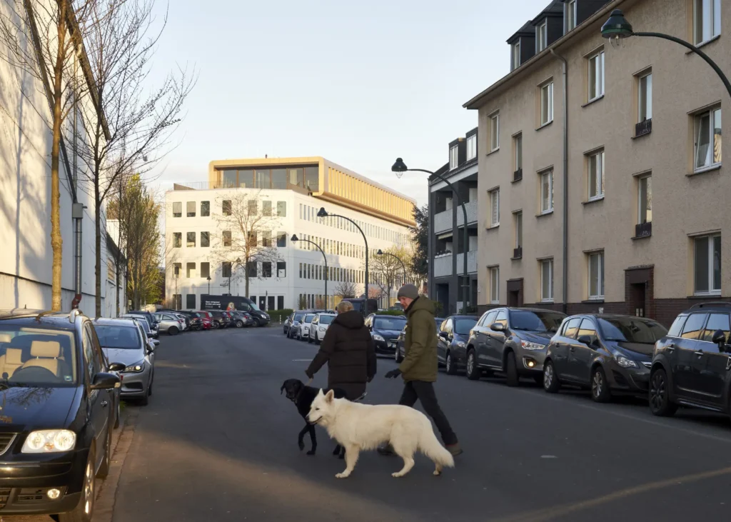 Person walking a dog near the Werft16 building in Düsseldorf