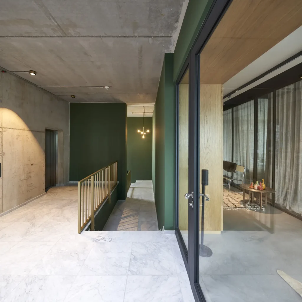 Lobby with green wall and staircase inside Werft16 by Kresings in Düsseldorf