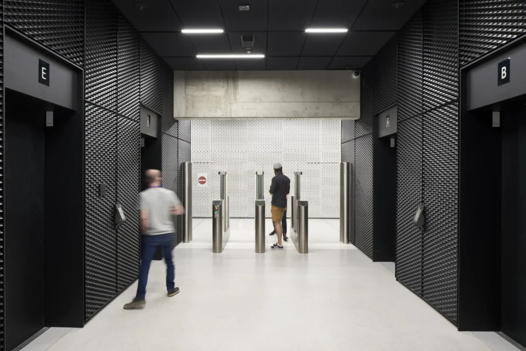 Black metal walls inside the lift core at UP! Berlin by Jasper Architects