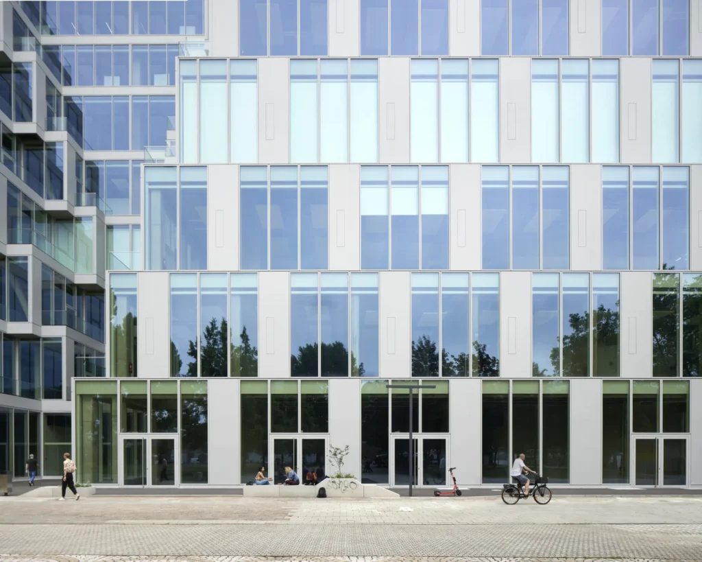 Geometric glass facade pattern reflecting surroundings at UP! Berlin by Jasper Architects