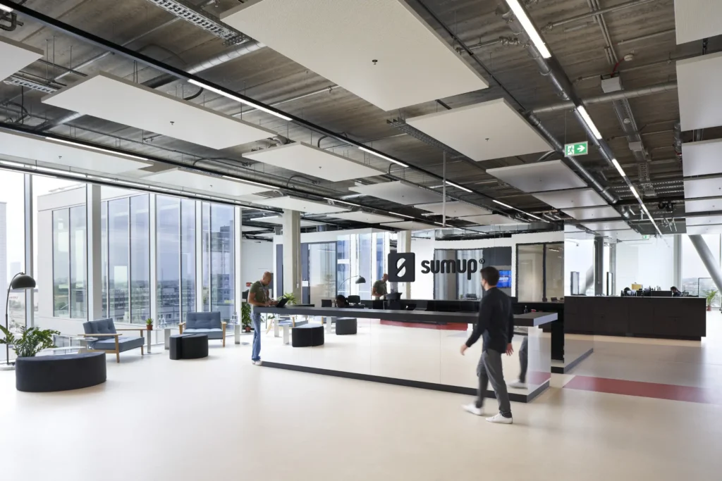 Sumup fromnt desk with industrial ceilings at UP! Berlin by Gewers Pudewill and Jasper Architects