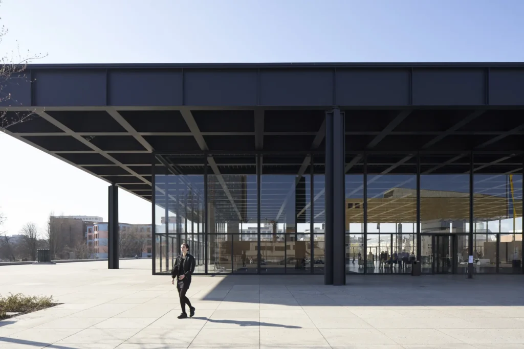 Side view of the entrance stairs at the Neue Nationalgalerie by Mies van der Rohe with woman