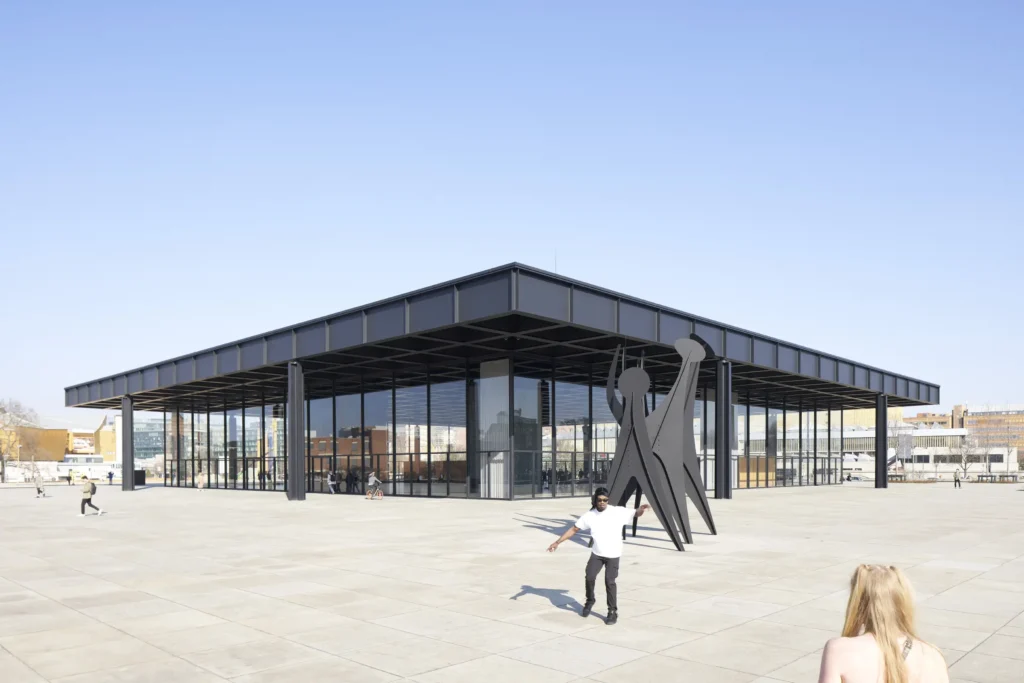 Dancing man in front of the corner of Neue Nationalgalerie showing the cantilevered steel roof in Berlin