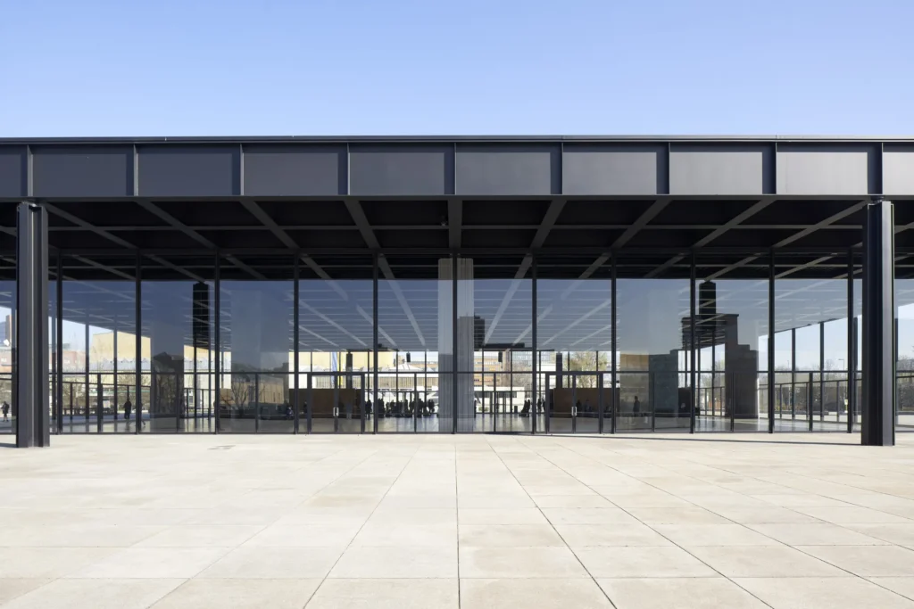 Steel roof structure and glass facade of the Neue Nationalgalerie seen from the podium