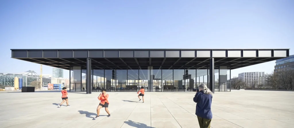 Photography and dance performance on the podium of Neue Nationalgalerie by Mies van der Rohe in Berlin with skyline in the background