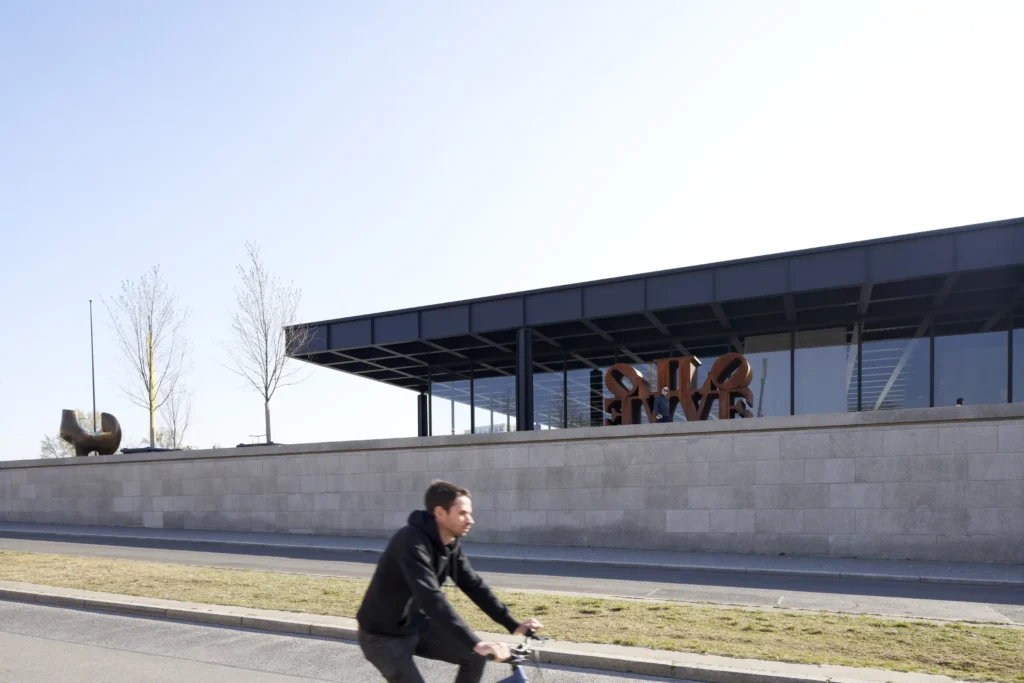 Cyclist riding past the Neue Nationalgalerie by Mies van der Rohe in Berlin