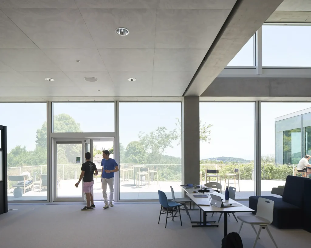 Students on a terrace of the SQUARE Learning Center with views over St. Gallen