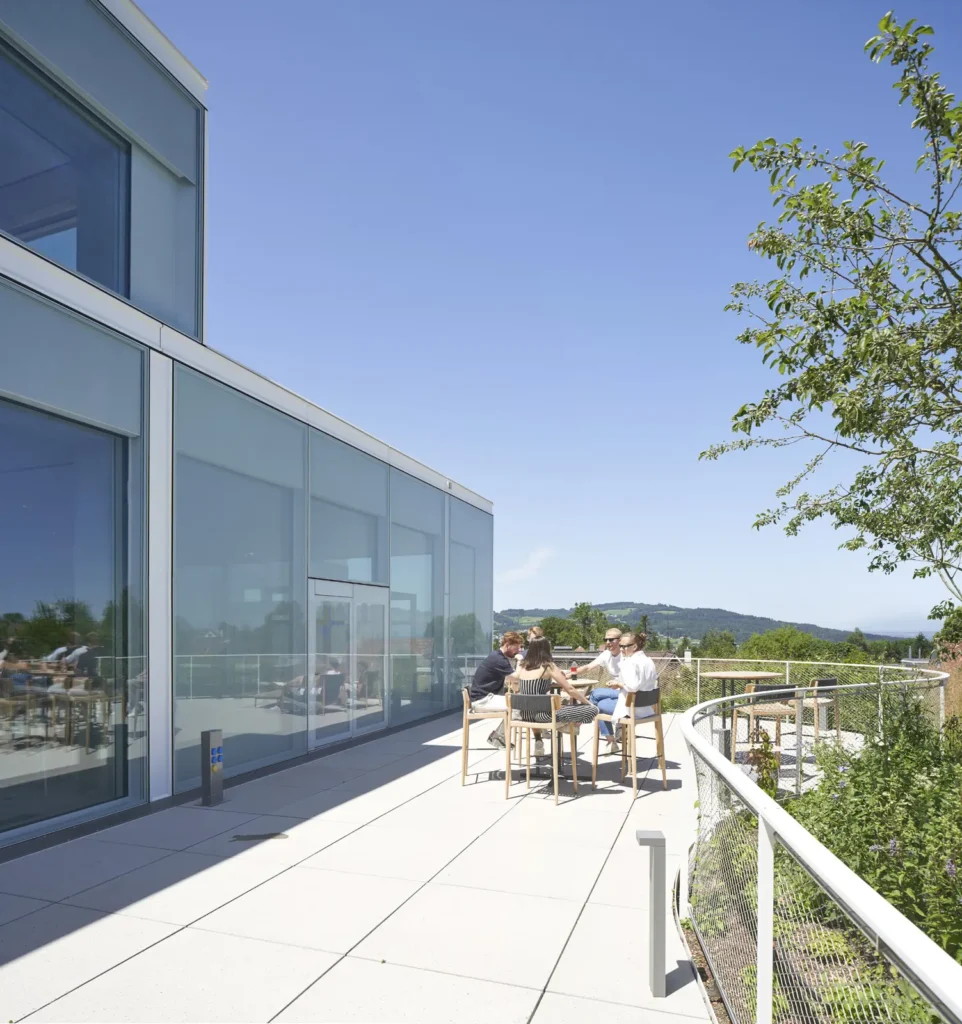 Students on a terrace of the SQUARE Learning Center with views over St. Gallen