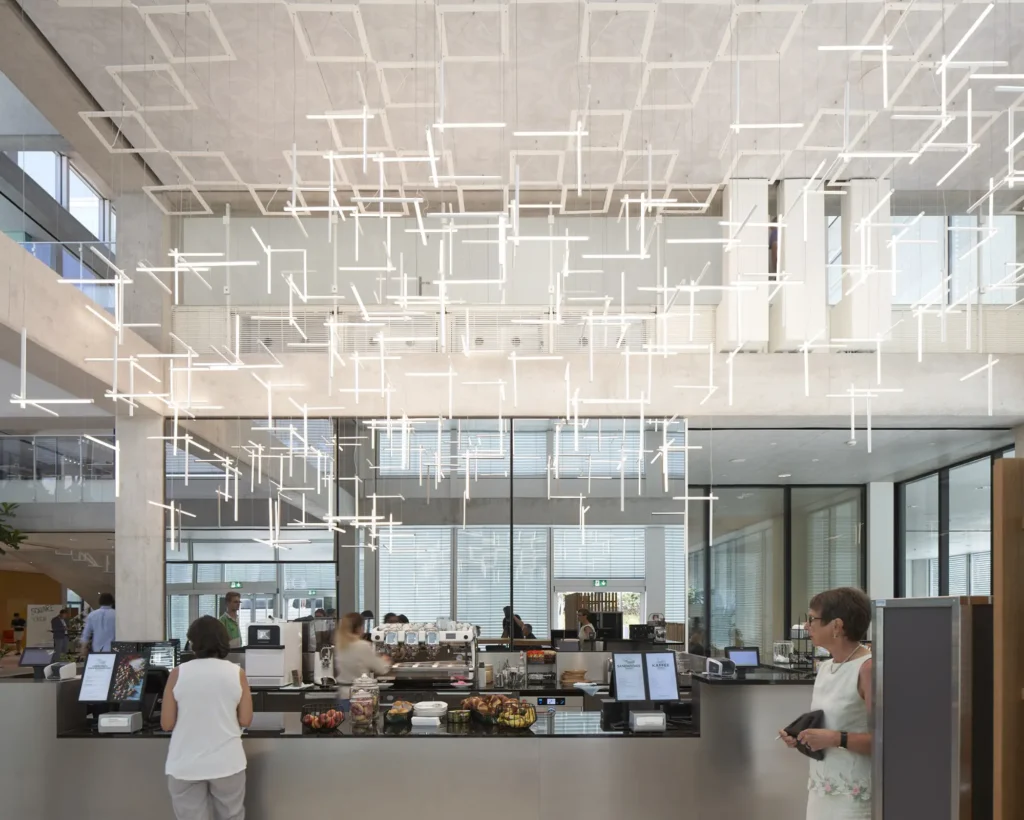 People at the cafe counter in the SQUARE Learning Center by Sou Fujimoto