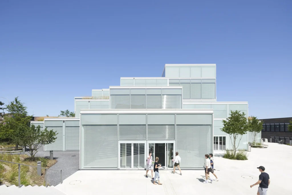 Students approaching the front entry at the SQUARE Learning Center by Sou Fujimoto