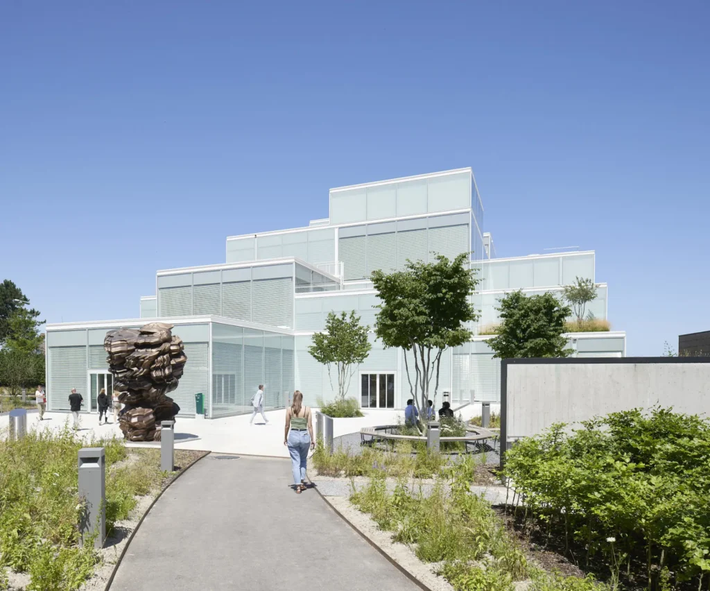 Students on the public square at the SQUARE Learning Center by Sou Fujimoto with solar louvers