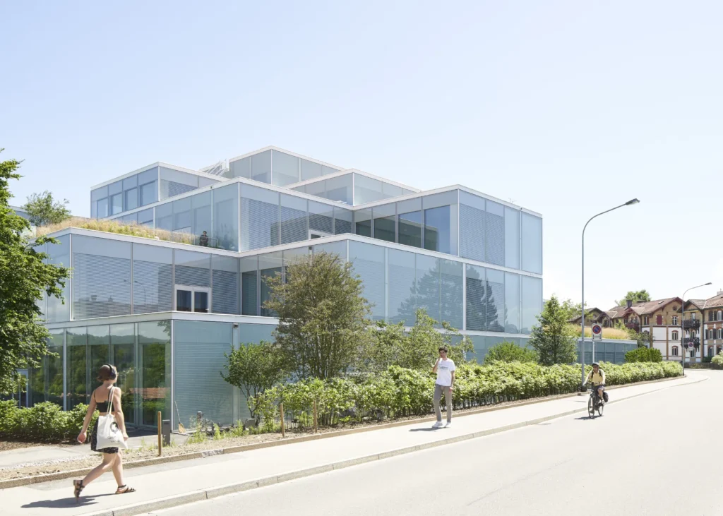 Pedestrians in front of SQUARE Learning Center by Sou Fujimoto at the University of St. Gallen with terraced glass volumes