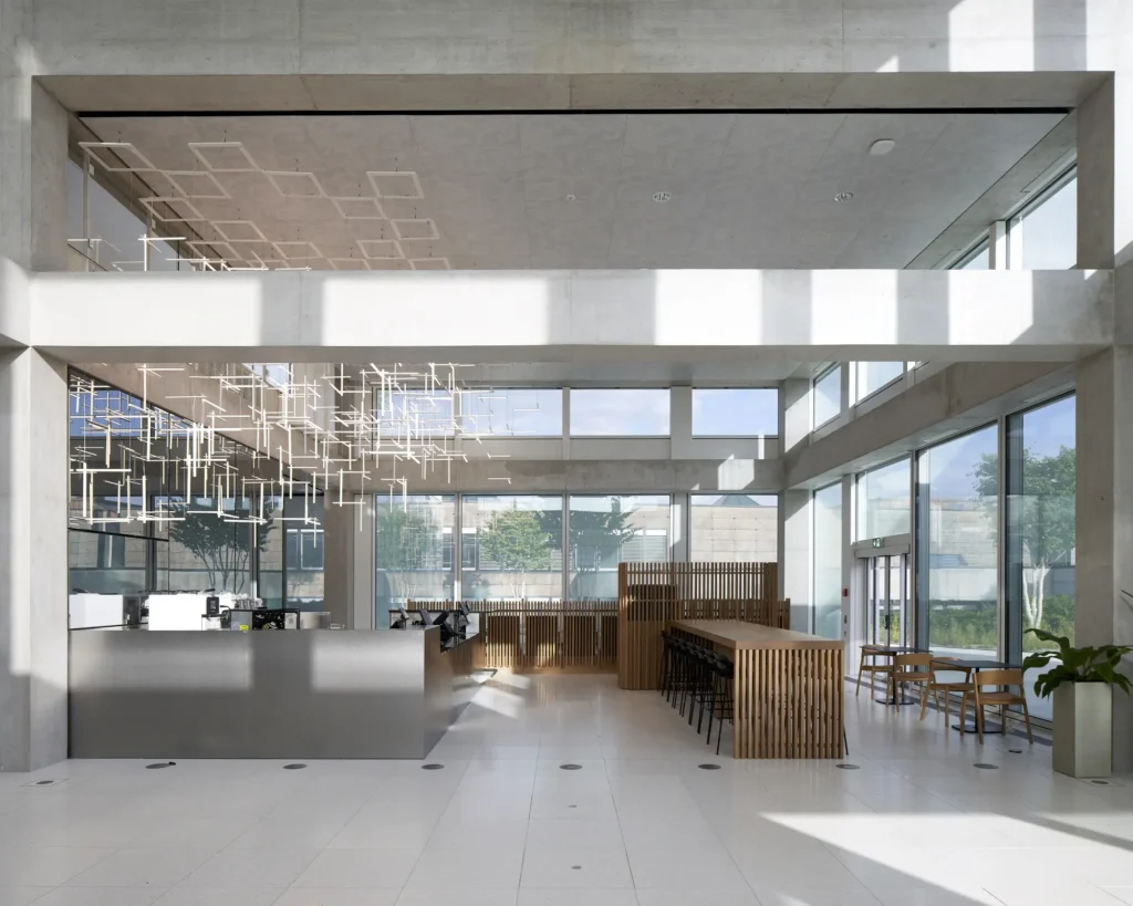 Cafe with timber counter and light-sculpture inside the SQUARE Learning Center in St. Gallen