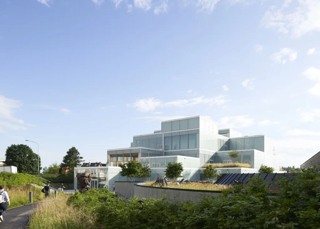 Students rushing to SQUARE Learning Center by Sou Fujimoto at the University of St. Gallen with terraced glass volumes