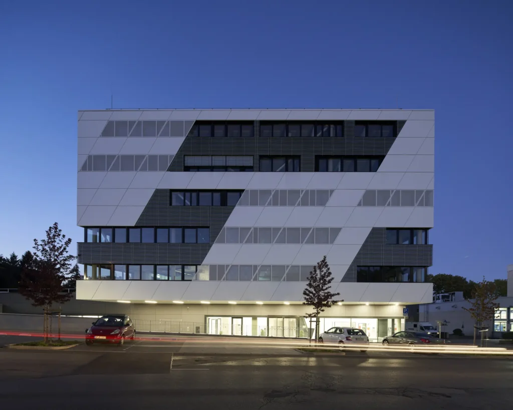 The illuminated lobby of the KMAC Center for Advanced Mobility at dusk in Aachen