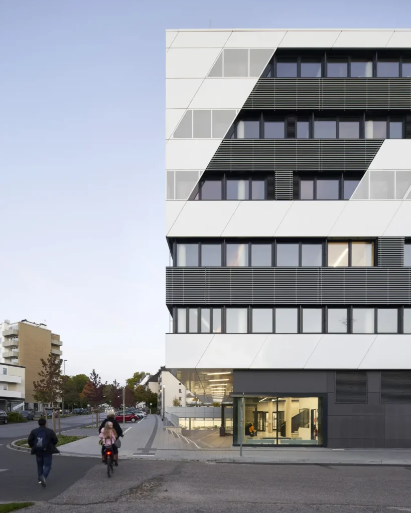 Illuminated entrance in the early morning light at KMAC building by studioMDA in Aachen