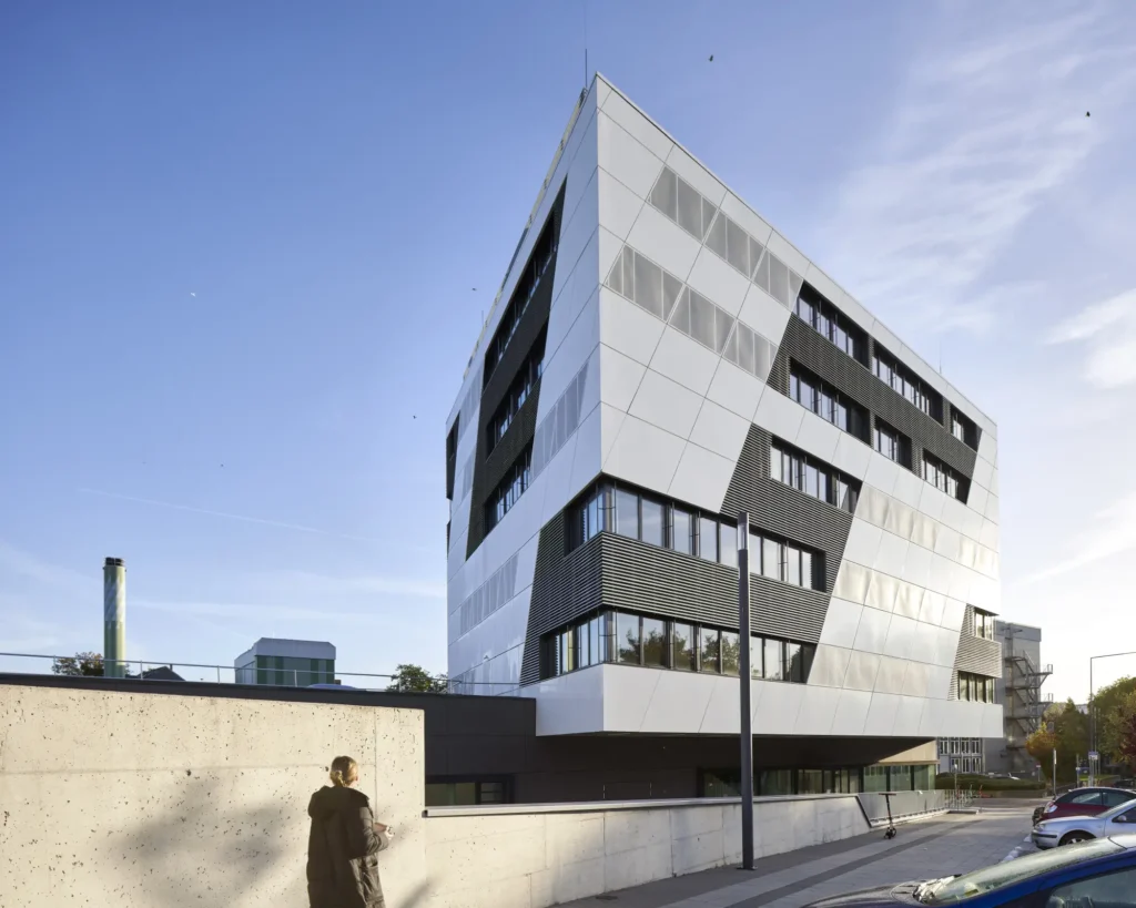 Woman walking towards KMAC Center for Advanced Mobility in Aachen