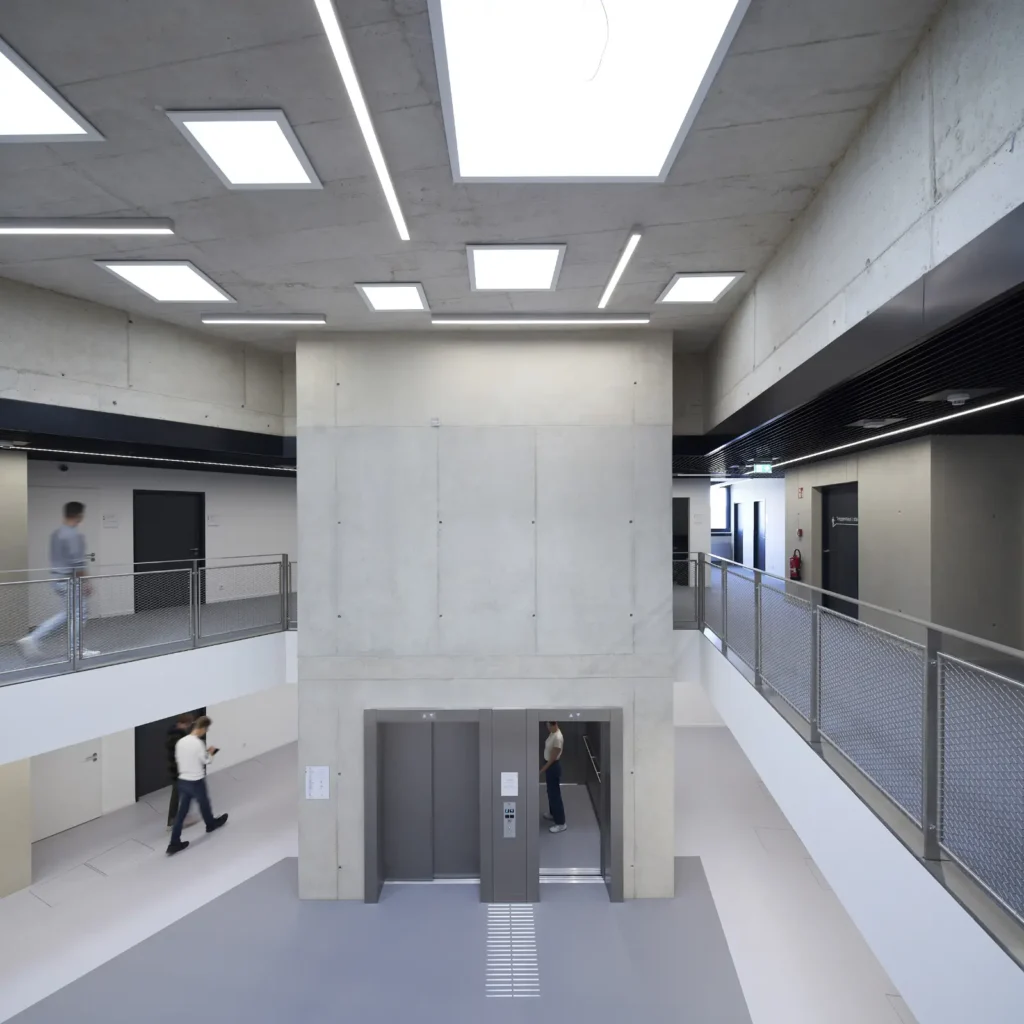 Lobby with skylights and lifts inside the KMAC building by studioMDA in Aachen