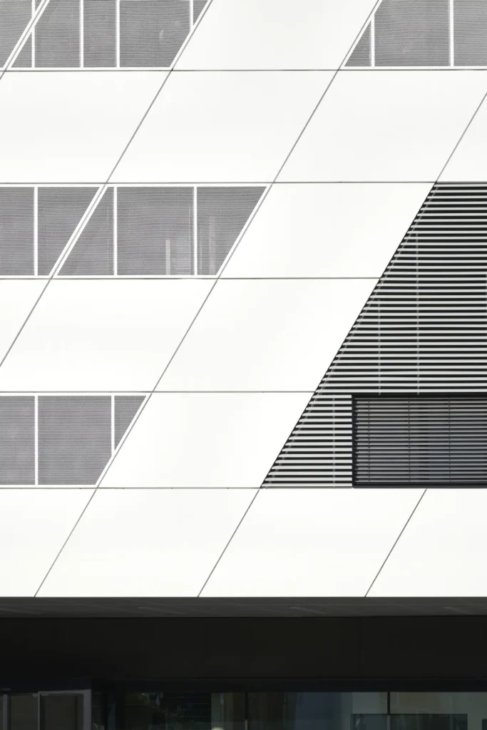 White panel facade with angled window strips at the KMAC by studioMDA