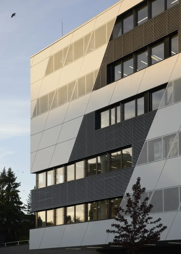 Golden evening light on the pattern of windows and louvres on the KMAC Center for Advanced Mobility
