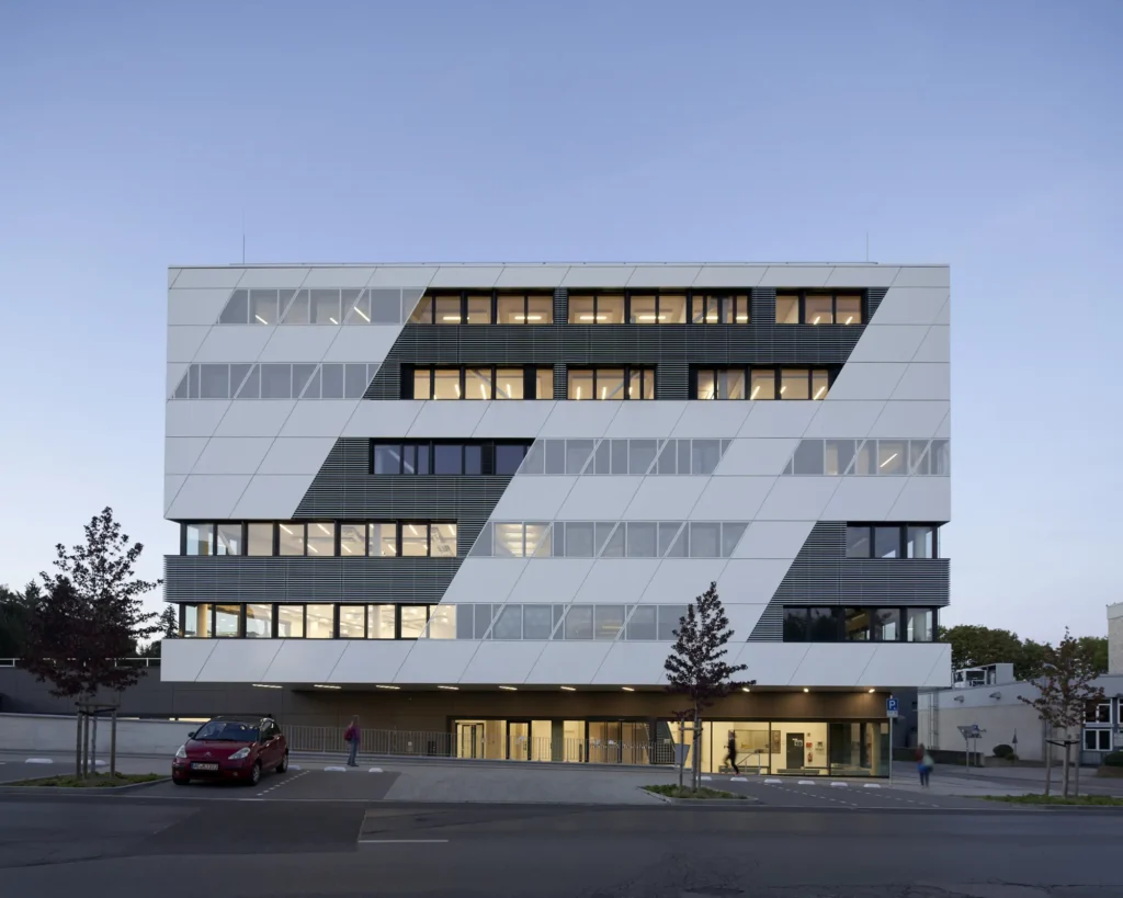 Offices illuminated inside the KMAC Center for Advanced Mobility at dusk in Aachen