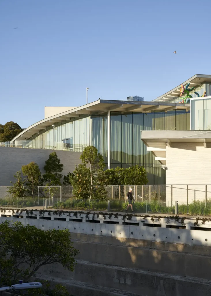 Full-height glazing and sandstone cubes of Sydney Modern gallery entrance by SANAA