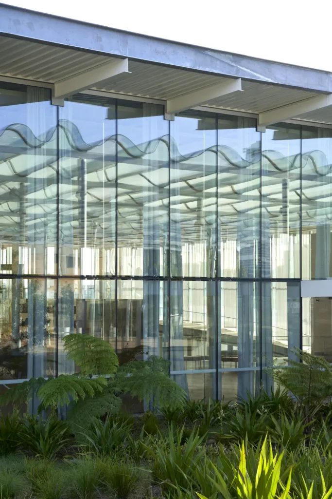 Crystalline glass facade of Sydney Modern reflecting landscape by SANAA architects