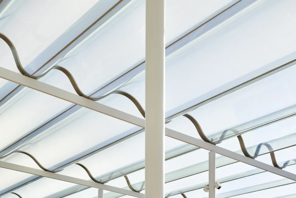 Undulating glass canopy with bronze wave supports at Sydney Modern by SANAA