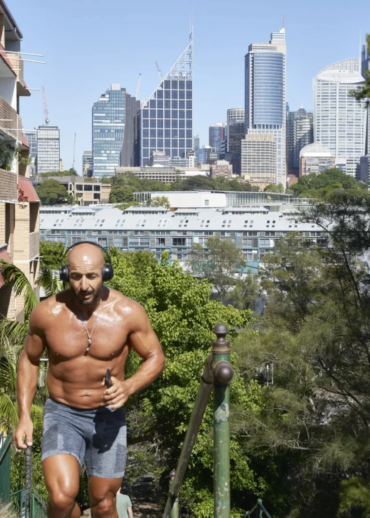 Man exercising with Sydney CBD skyline and Sydney Modern in background