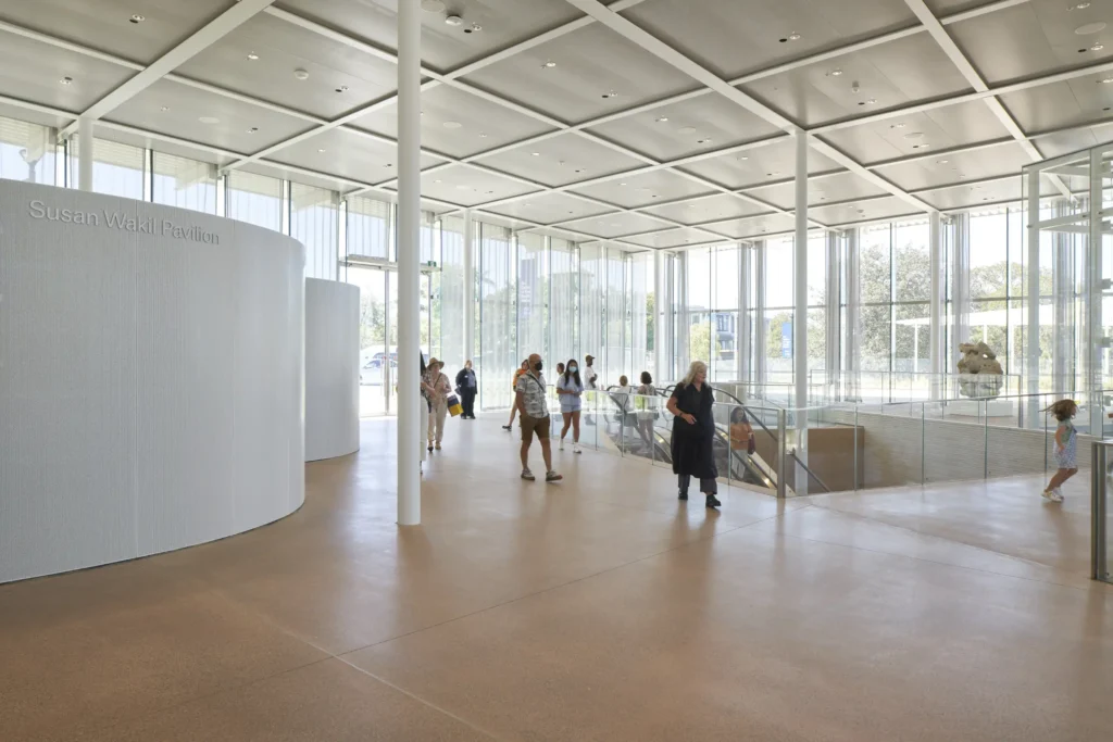 Staircase viewed from above in light-filled atrium at Sydney Modern with visitors