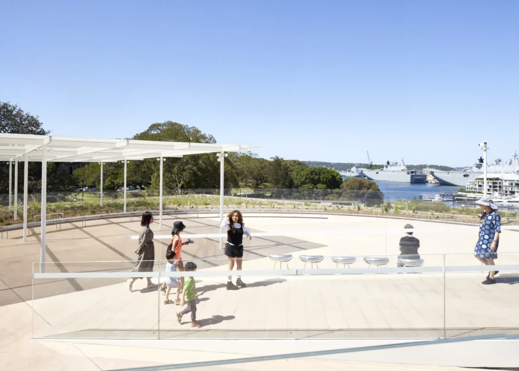 Outdoor café terrace with visitors at Sydney Modern art gallery and harbour views