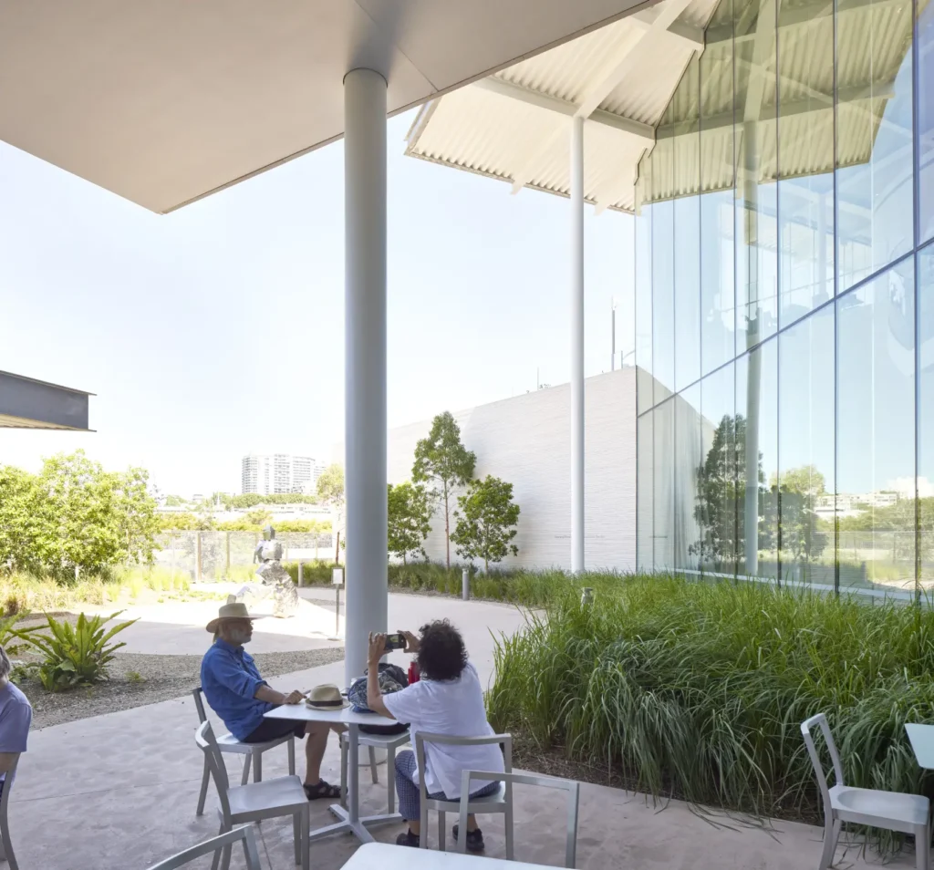 People seated at café beneath canopy at Sydney Modern by SANAA