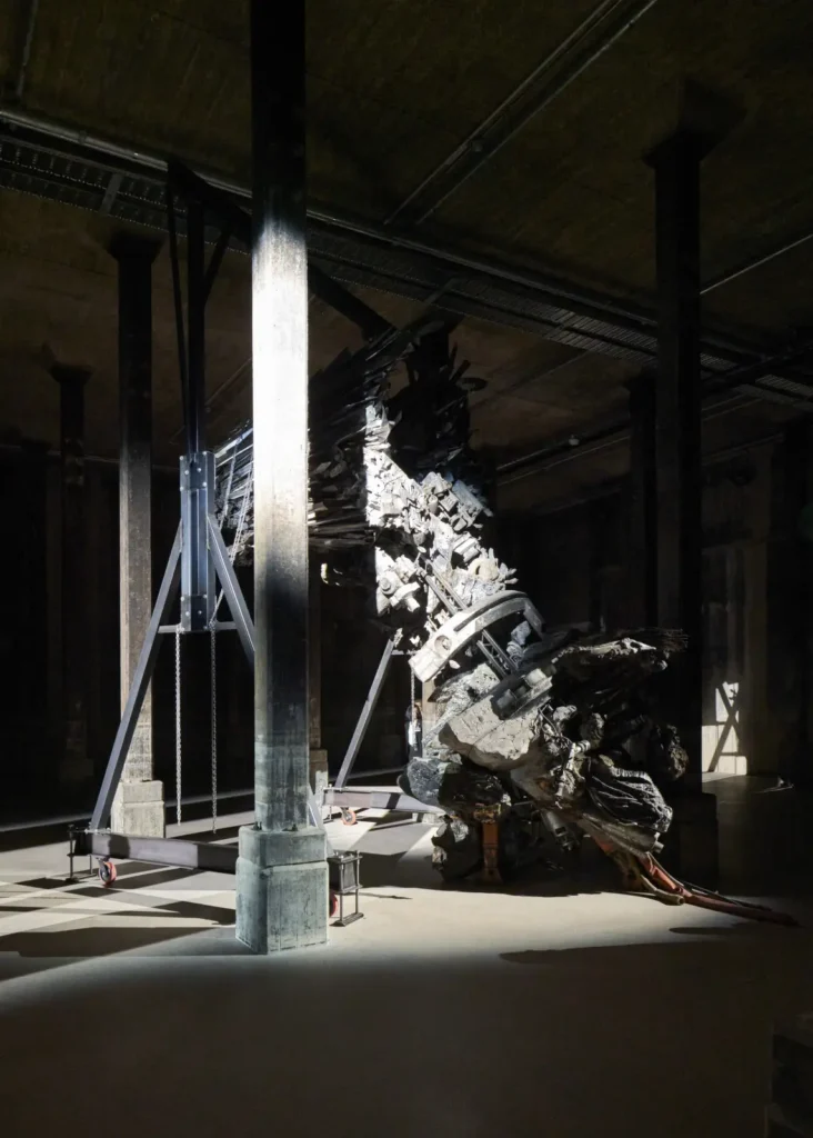 Dramatic underground gallery with raw concrete columns and art installation at Sydney Modern