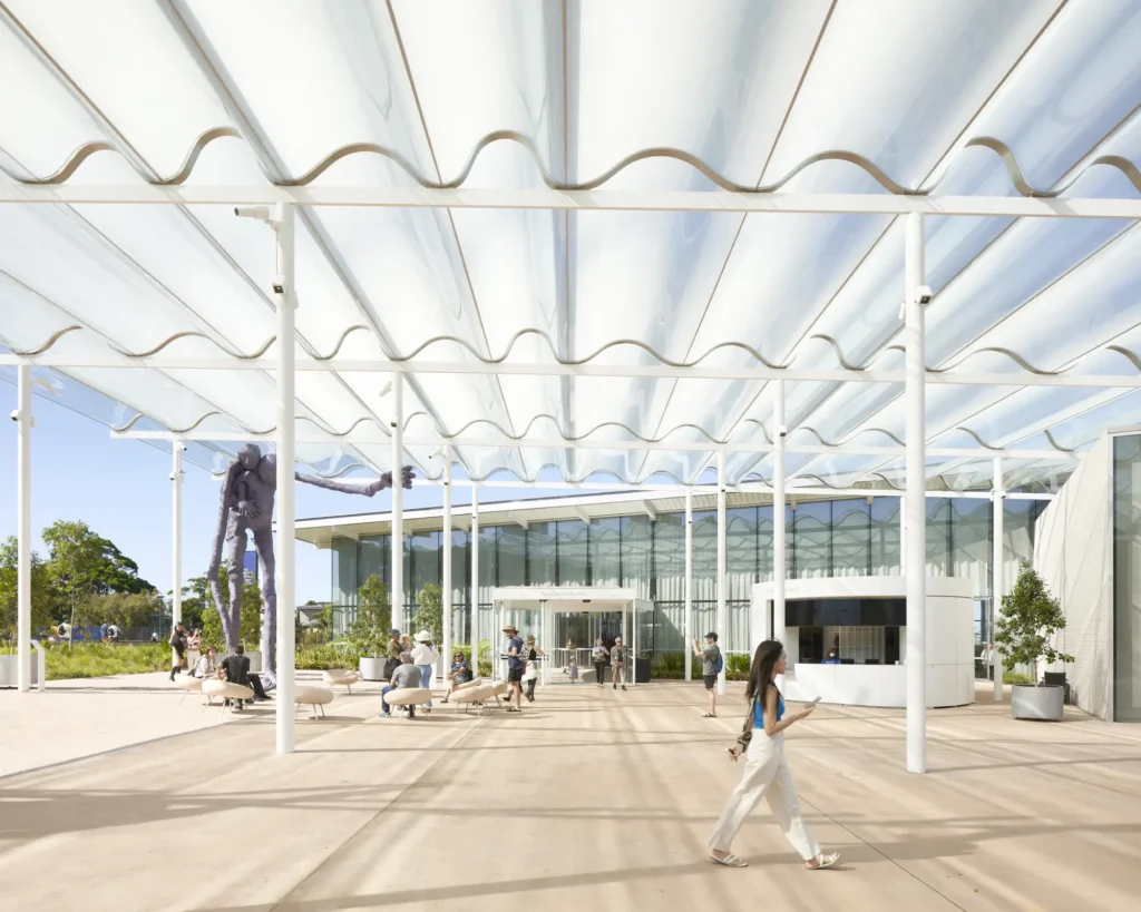 Entrance plaza of Sydney Modern with families and glass pavilion behind