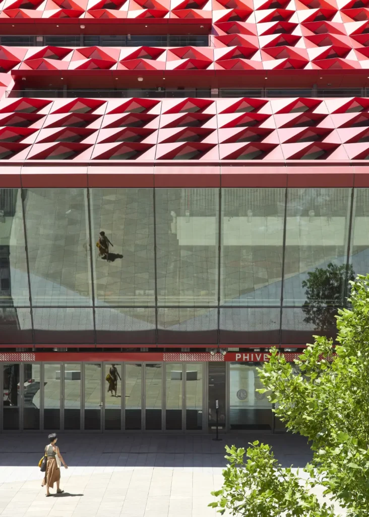 Woman walking towards the entry of the PHIVE Community Center on a sunny day in Parramatta Sydney